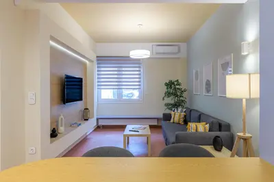 a living room with a couch and a table at Acropolis walking distance apartment in Athens