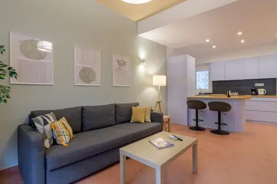 a living room with a couch and a table at Acropolis walking distance apartment in Athens