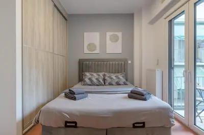 a bedroom with a bed with towels on it at Acropolis walking distance apartment in Athens