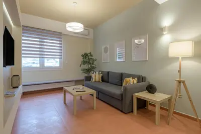 a living room with a couch and a table at Acropolis walking distance apartment in Athens