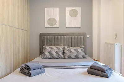 a bedroom with a bed with towels on it at Acropolis walking distance apartment in Athens