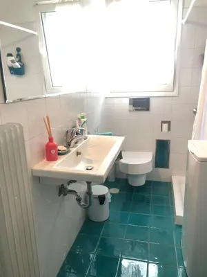 a bathroom with a sink and a toilet at Sweet Apartment By The Sea in Athens