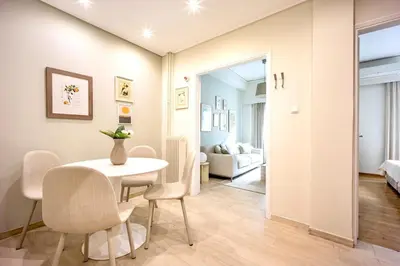 a dining room and living room with a table and chairs at Cozy Home 3 min walk from Ancient Agora in Athens