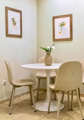 a table and chairs with a vase on top of it at Cozy Home 3 min walk from Ancient Agora in Athens