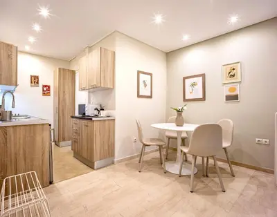 a kitchen and dining room with a table and chairs at Cozy Home 3 min walk from Ancient Agora in Athens