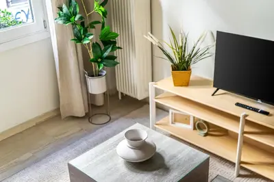 a living room with a tv and a coffee table at Cozy Home 3 min walk from Ancient Agora in Athens