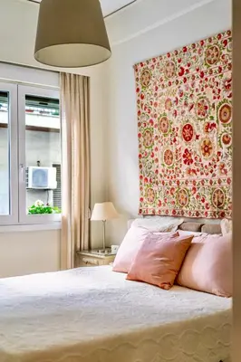 a bedroom with a large bed with pink pillows at Cozy Home 3 min walk from Ancient Agora in Athens
