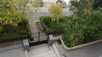 an overhead view of a garden with a bench and trees at George Luxury Apartments in Athens