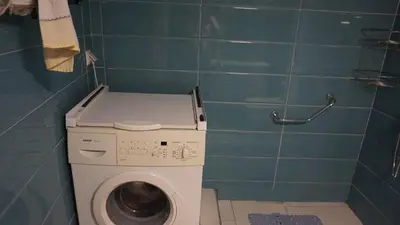 a small bathroom with a washing machine in it at George Luxury Apartments in Athens