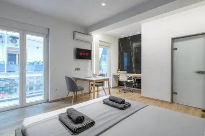 a bedroom with a bed and a table and chairs at New Korinis 3 Athens studio in Athens
