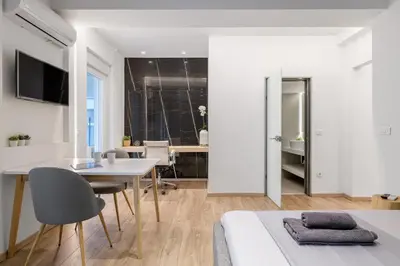 a bedroom with a bed and a table and chairs at New Korinis 3 Athens studio in Athens