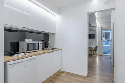a kitchen with white cabinets and a microwave at New Korinis 3 Athens studio in Athens