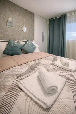 a bedroom with two beds with towels on them at Luxury Retreat with Iconic Acropolis View Koukaki in Athens