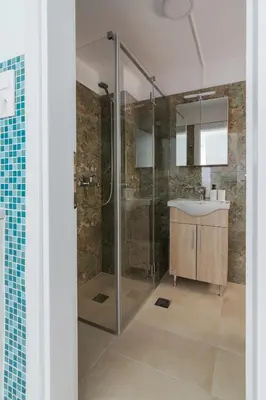 a bathroom with a shower and a sink at Luxury Retreat with Iconic Acropolis View Koukaki in Athens