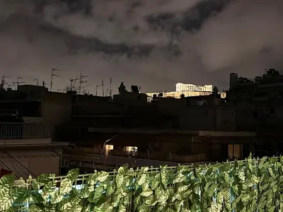 a view of a city with buildings in the background at Luxury Retreat with Iconic Acropolis View Koukaki in Athens