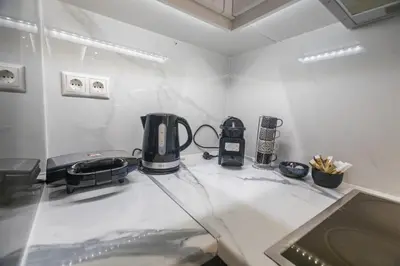 a counter top with a coffee maker on it at varkiza luxury 2BD apartment in Vari