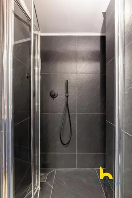 a bathroom with a shower with a glass door at Unique Urban Cave w Pool Table Near Acropolis! in Athens