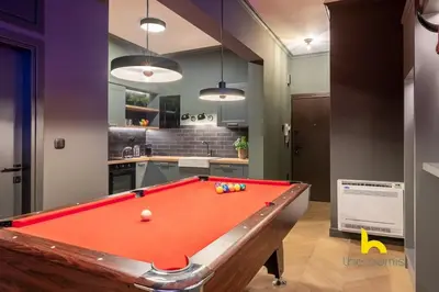 a room with a pool table in a kitchen at Unique Urban Cave w Pool Table Near Acropolis! in Athens