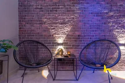 two chairs sitting in front of a brick wall at Unique Urban Cave w Pool Table Near Acropolis! in Athens
