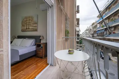 a balcony with a bed and a table on a balcony at Steps from the Heart of Zografou- 3 Guests by ΜΡS in Athens