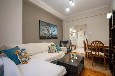 a living room with two couches and a table at Steps from the Heart of Zografou- 3 Guests by ΜΡS in Athens