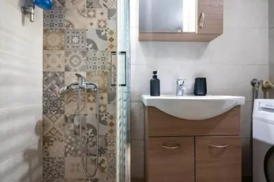 a bathroom with a sink and a shower at Steps from the Heart of Zografou- 3 Guests by ΜΡS in Athens