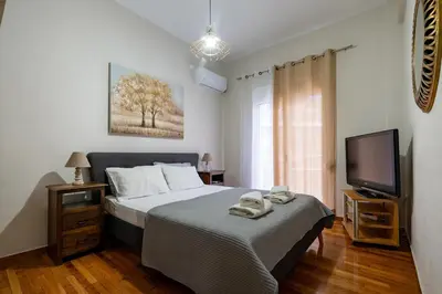 a bedroom with a bed with two towels on it at Steps from the Heart of Zografou- 3 Guests by ΜΡS in Athens
