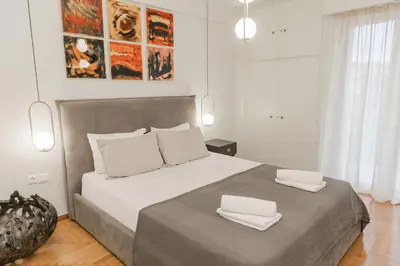 a bedroom with a large bed with two white pillows at Acropolis experience apartment! in Athens