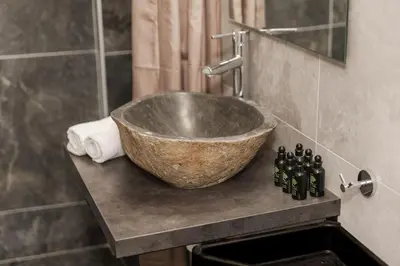 a bathroom with a bowl sink on a counter at Acropolis experience apartment! in Athens