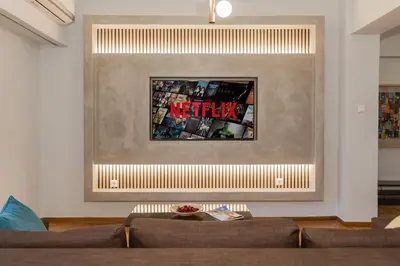 a living room with a couch and a picture on the wall at Acropolis experience apartment! in Athens