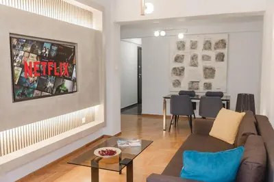 a living room with a couch and a table at Acropolis experience apartment! in Athens