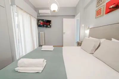 a room with a large bed with towels on it at Acropolis experience apartment! in Athens