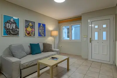 a living room with a couch and a table at Two steps from Acropolis in Athens