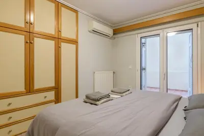 a bedroom with a bed with two towels on it at Two steps from Acropolis in Athens