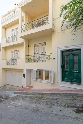 a building with a green door and windows at Two steps from Acropolis in Athens