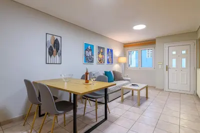 a living room with a table and a couch at Two steps from Acropolis in Athens