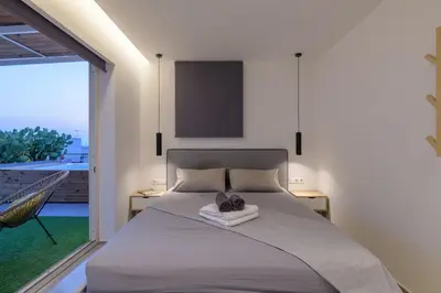 a bedroom with a bed and a large window at Jacuzzi Penthouse with sea view 5th floor in Athens