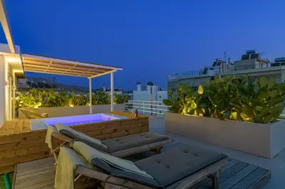 a rooftop deck with a hot tub on a roof at Jacuzzi Penthouse with sea view 5th floor in Athens