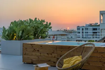 a hot tub on the roof of a building at Jacuzzi Penthouse with sea view 5th floor in Athens