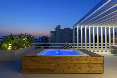 a hot tub on the roof of a building at Jacuzzi Penthouse with sea view 5th floor in Athens