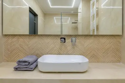 a bathroom with a white sink and a mirror at Brand new 3bedrooms apartment in Athens