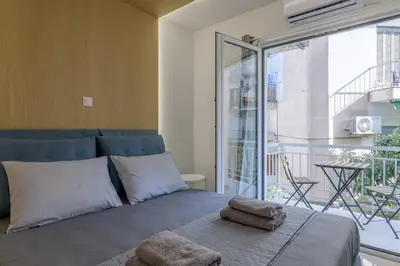 a bedroom with a bed with towels on a balcony at Brand new 3bedrooms apartment in Athens