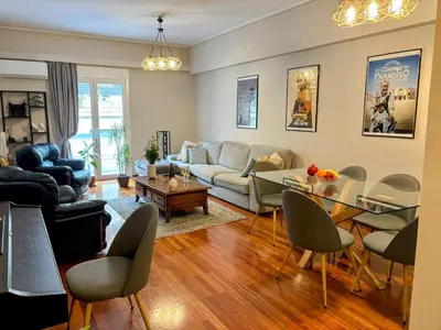 a living room with a couch and a table at Amalia cosy home in Athens