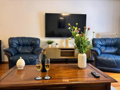a living room with a table with two glasses of wine at Amalia cosy home in Athens