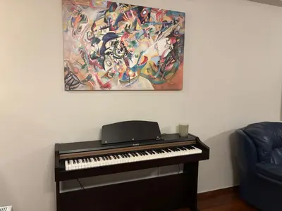 a piano in a room with a painting on the wall at Amalia cosy home in Athens
