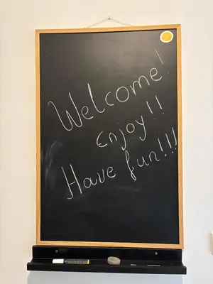 a chalkboard with the words welcome everyonday have fun at Amalia cosy home in Athens
