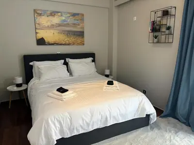 a bedroom with a bed with two books on it at Amalia cosy home in Athens