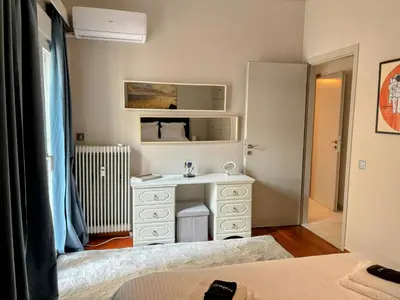a bedroom with a white dresser and a sink at Amalia cosy home in Athens