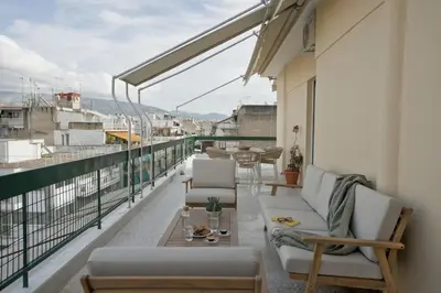 a balcony with chairs and tables on a building at Fireside Kallithea - Large Veranda II - 3BR by ΜΡS in Athens