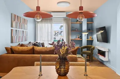 a living room with a vase of flowers on a table at Fireside Kallithea - Large Veranda II - 3BR by ΜΡS in Athens